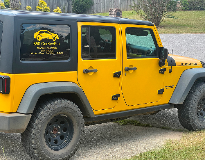 A bright yellow Jeep Wrangler with an 850 Car Key Pro decal on the window.